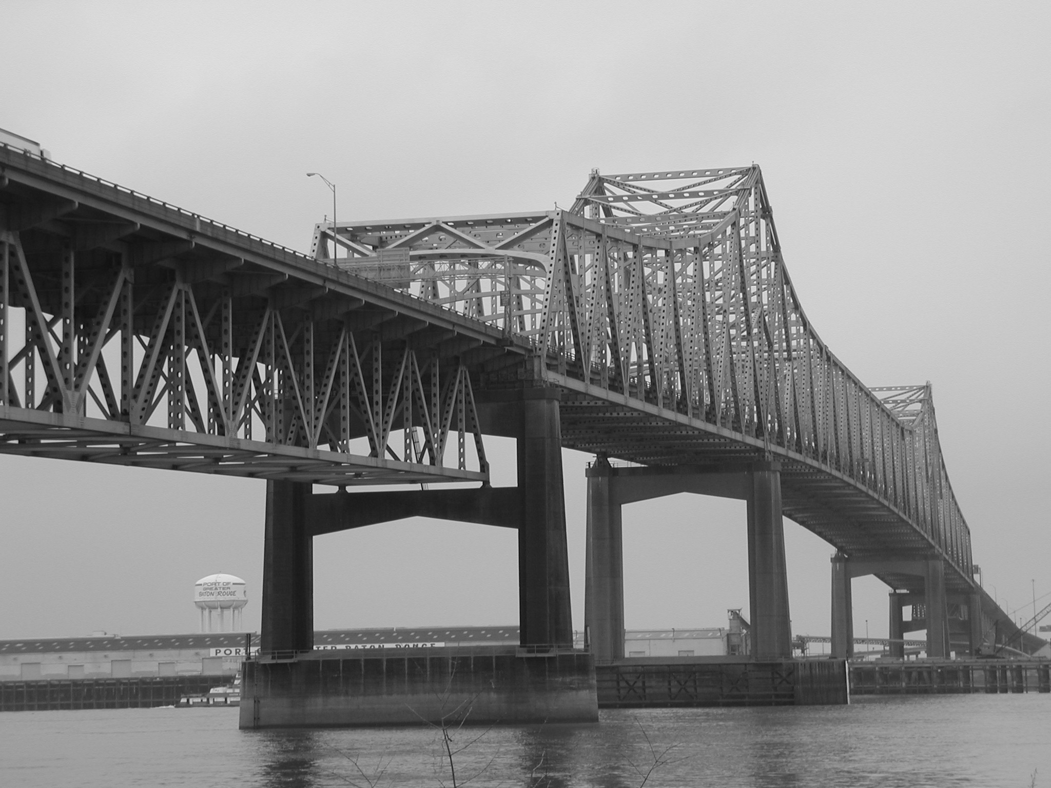 a black and white picture of a bridge over water