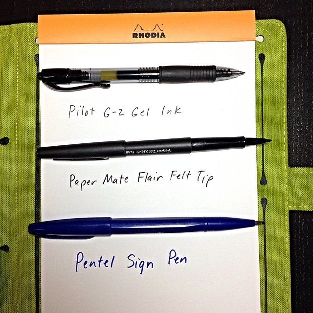 pens sit on a white piece of paper near each other