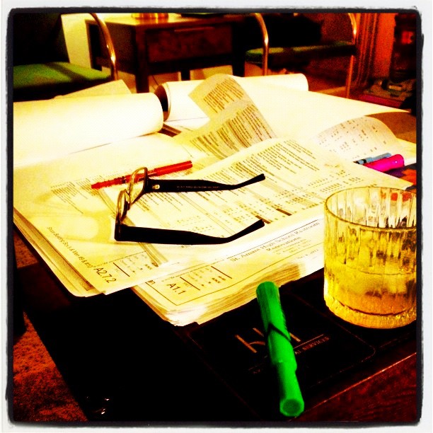 a drink and some papers on a desk