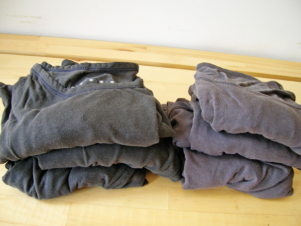 grey folded clothing displayed on wooden surface for consumption