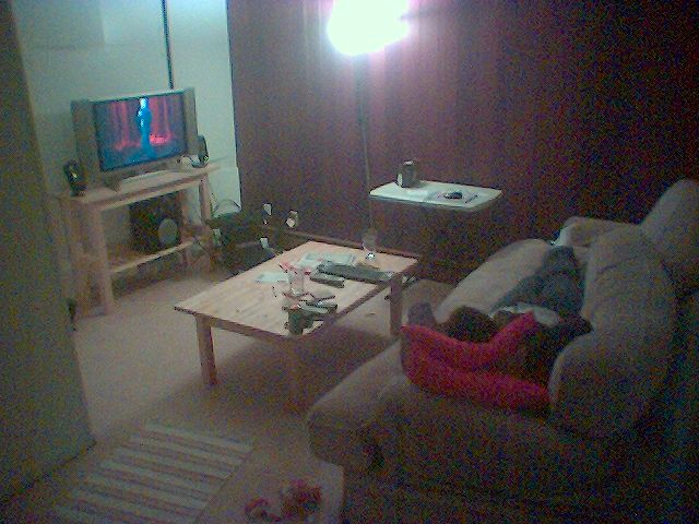 a living room with the television on is illuminated by a bright light