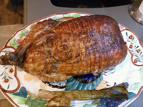 a large cooked roast beef is on a colorful plate