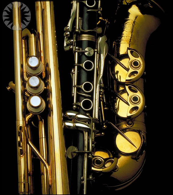 a close up of a saxophone on a dark background