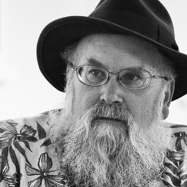 black and white portrait of man with hat and glasses