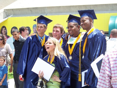 several people standing and posing for a po with graduates