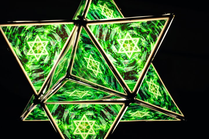 a star that is made of green and white swirls