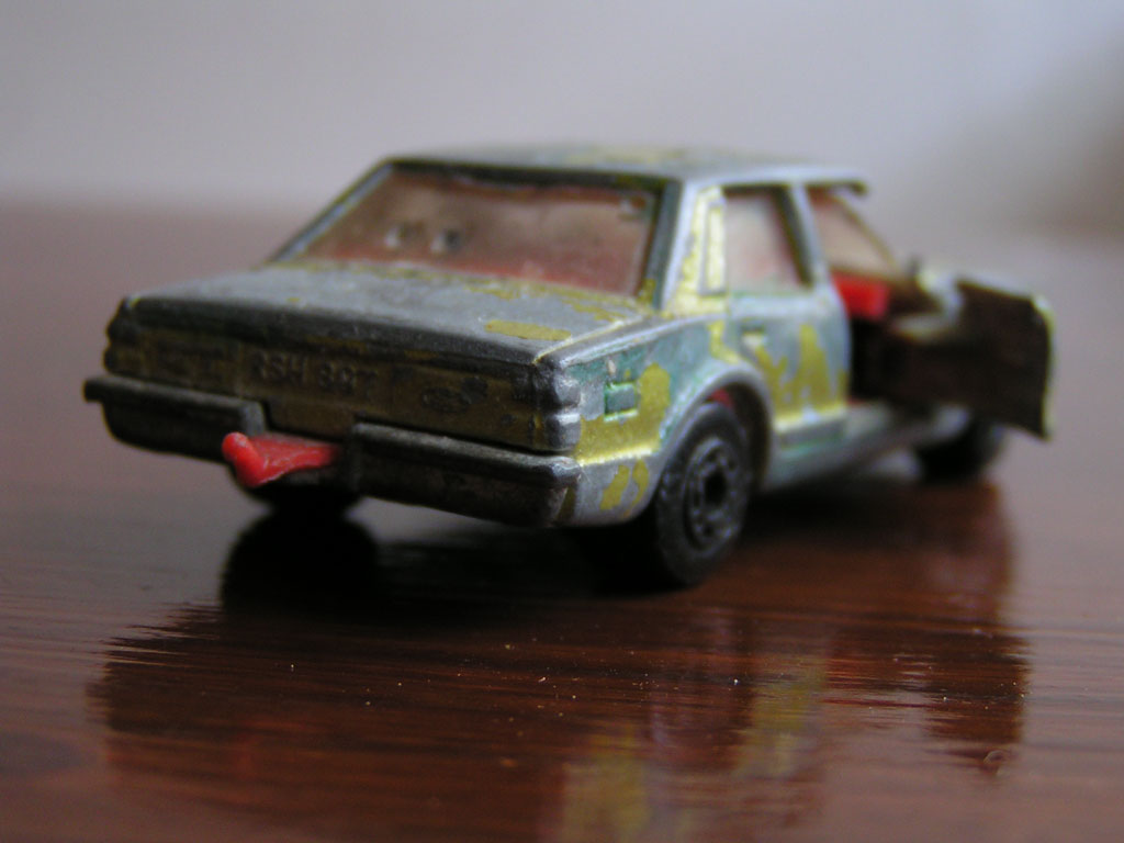 a toy car sitting on top of a wooden table