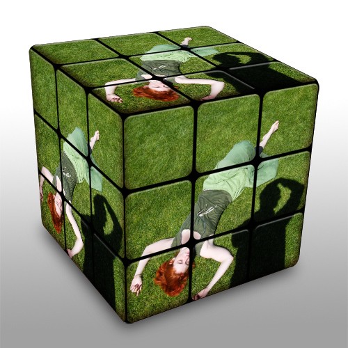 a cube is decorated with pictures of a woman lying on the grass