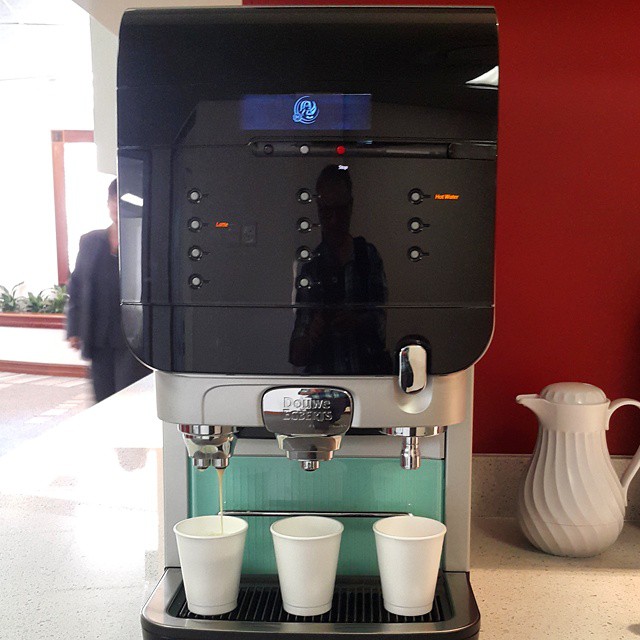 two cups being operated by a machine in a room