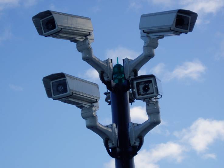 surveillance cameras attached to a metal pole