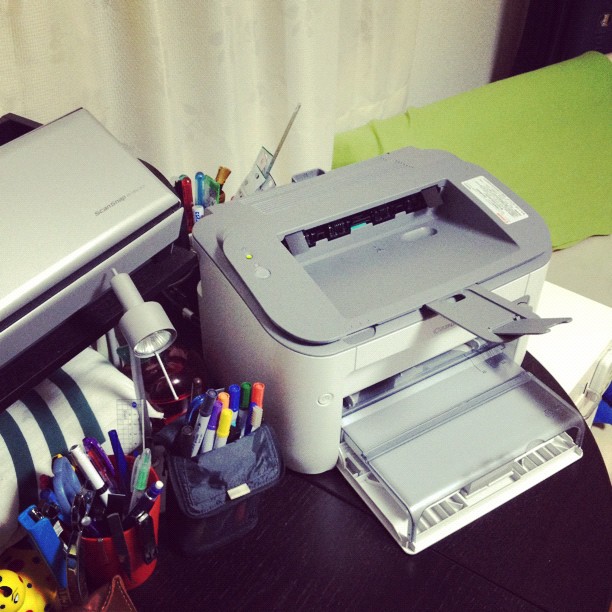 a printer and other office supplies on a desk