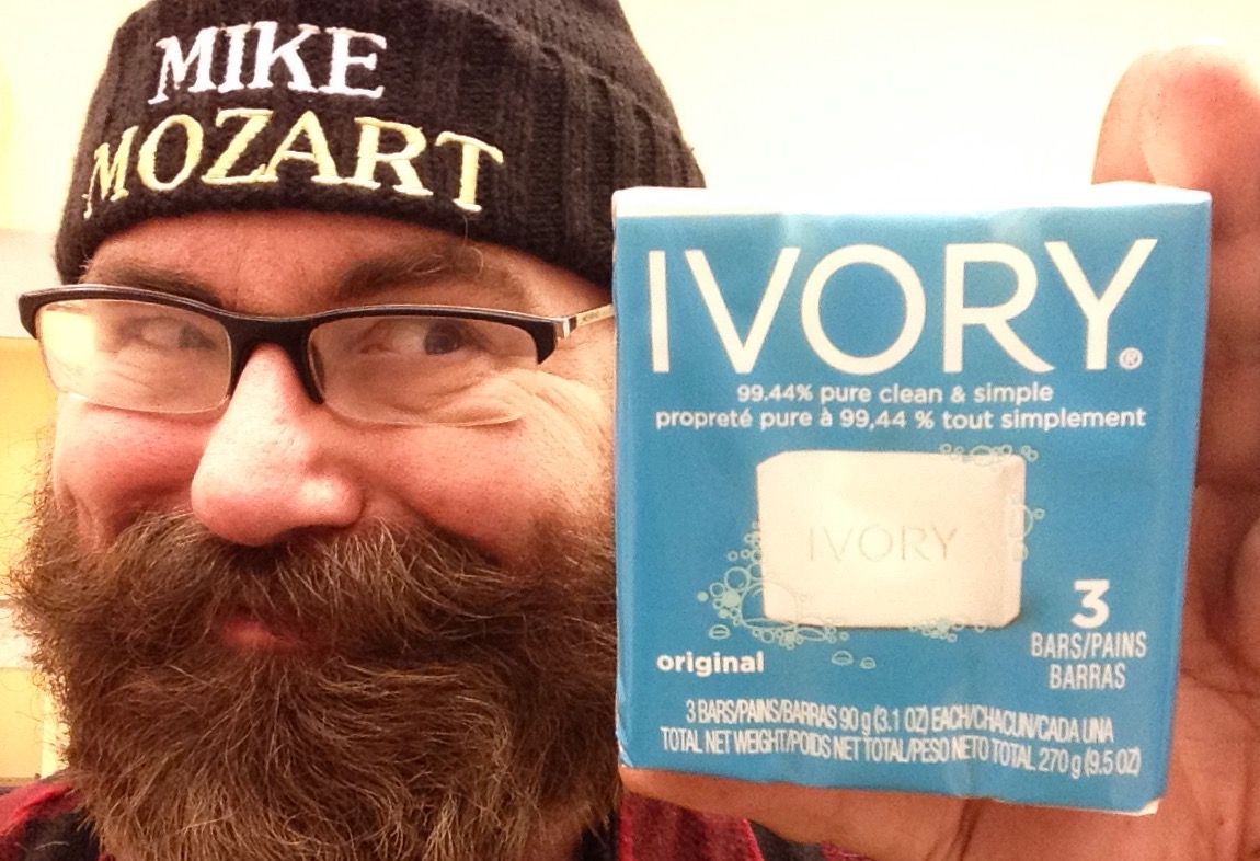 man with a beard holding up a package of ivvory