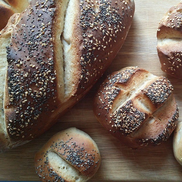 some loaves of bread with sesame seeds on top
