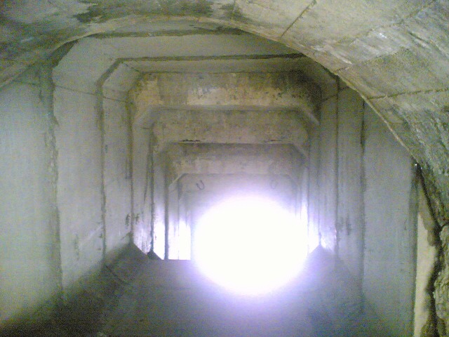 a tunnel with sunlight coming through from the light