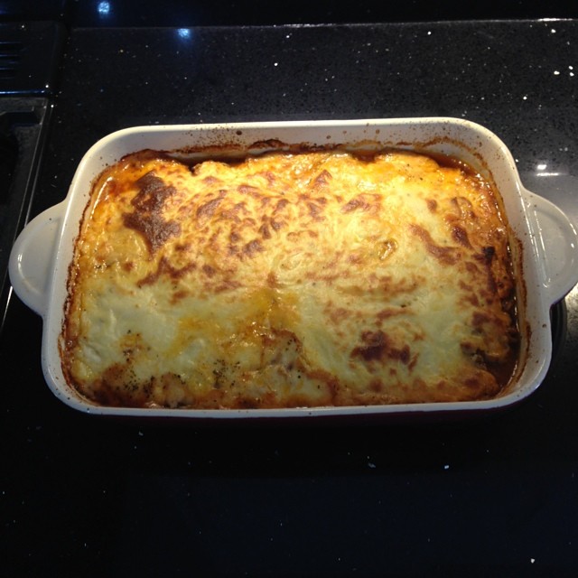 a dish filled with cheese casserole on top of a stove