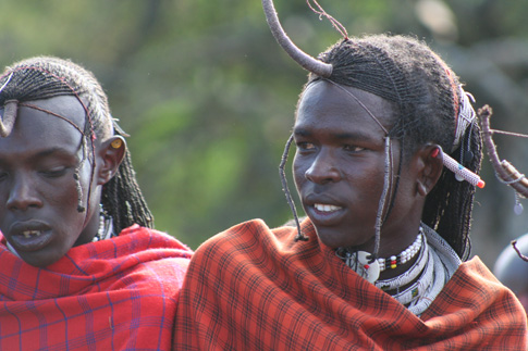 two people wearing horned headdress and scarves