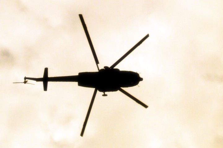 a large propeller helicopter flying through the sky