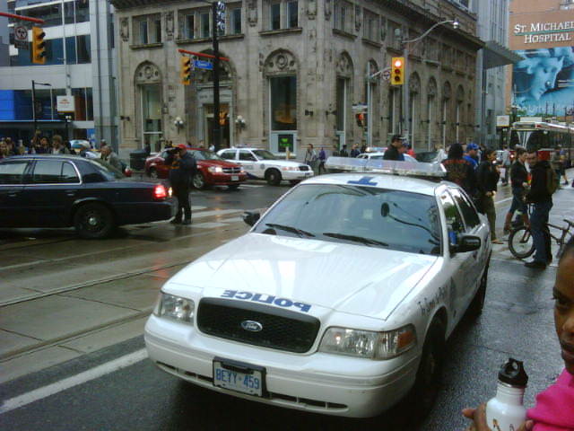 the police car is on the busy street