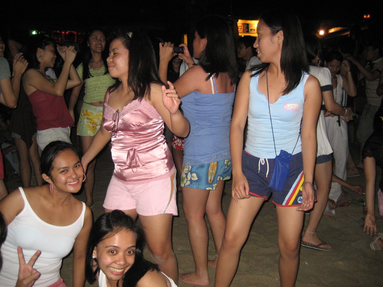 the two girls are standing next to the other girls at a party