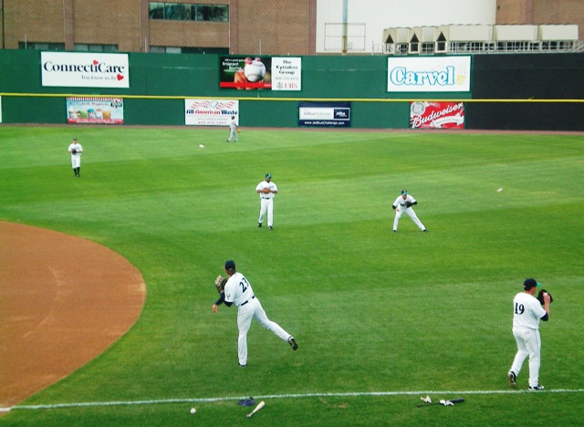the men are playing baseball on the field
