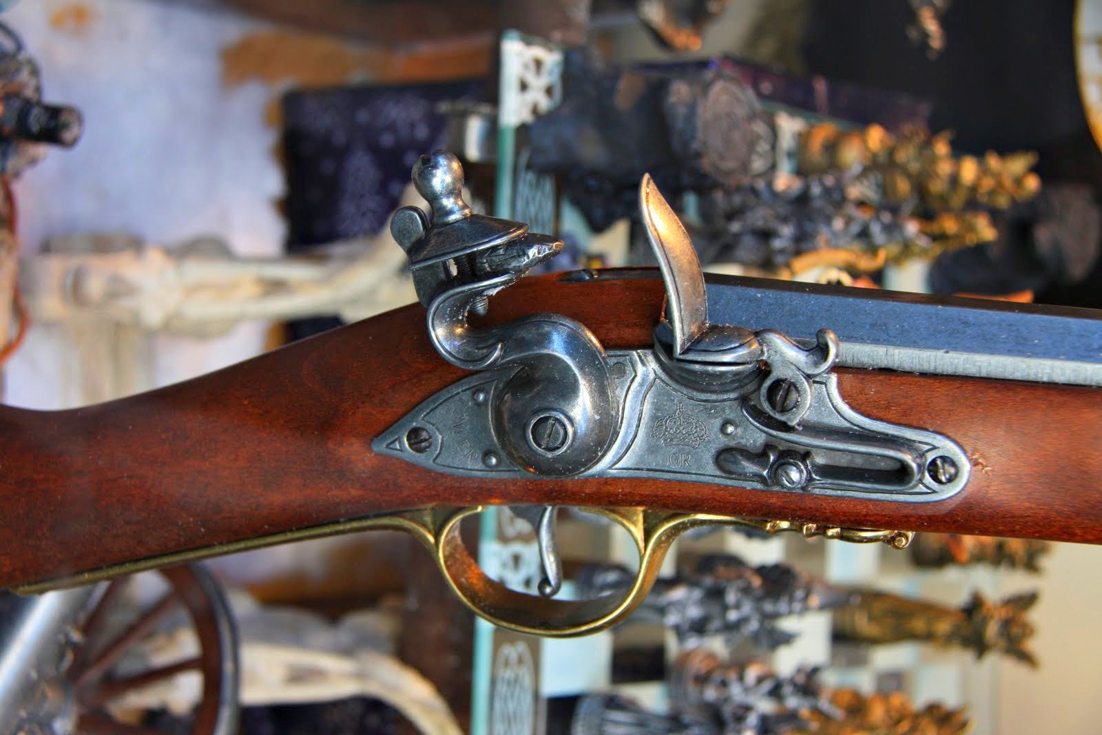 an antique gun with metal trigger on it