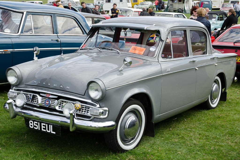 a grey car that is sitting in the grass