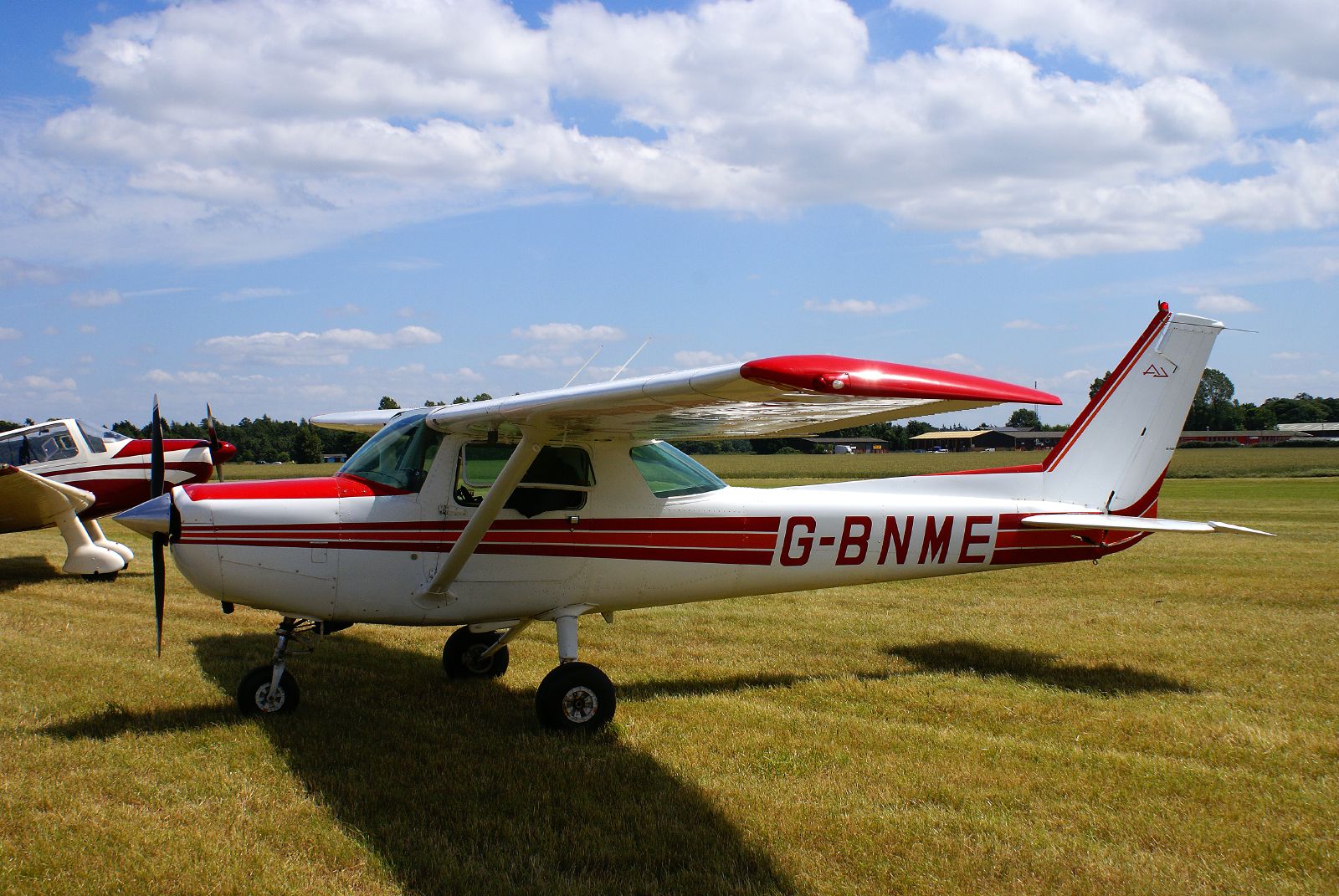 small airplane sitting in the grass on the grass