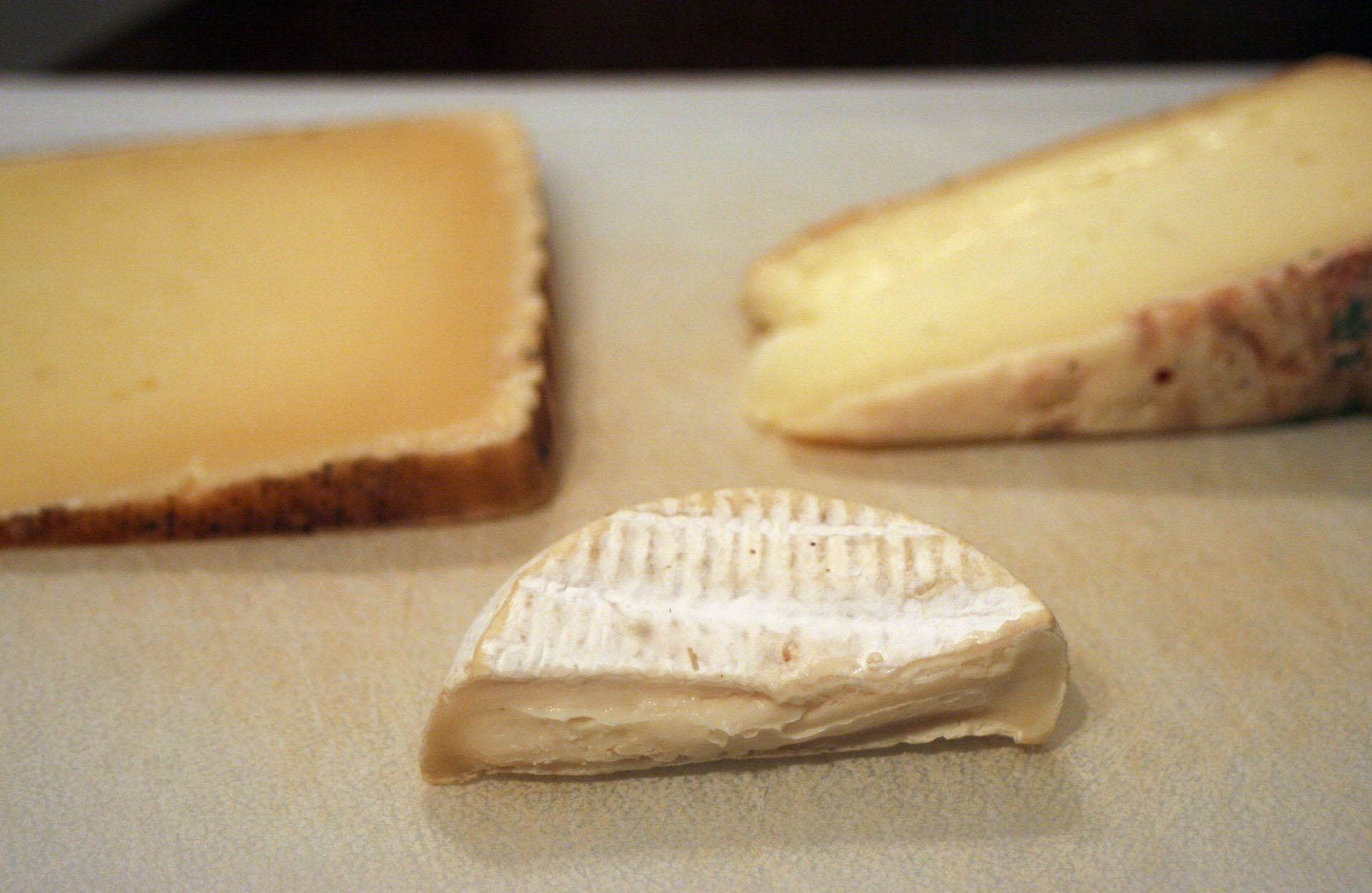 several slices of cheese are on a white surface