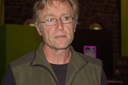 a man is wearing glasses and looking into the camera
