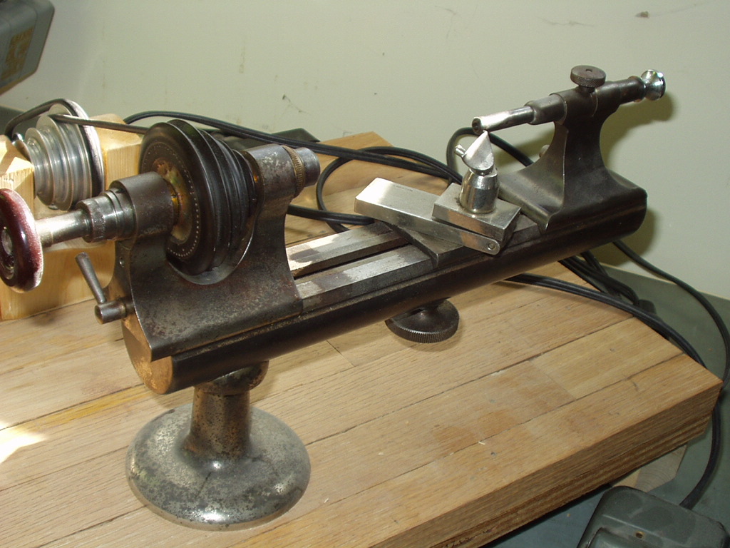 the lathe is being held onto a  board