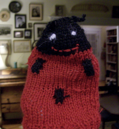a hand made red sweater with a black nose
