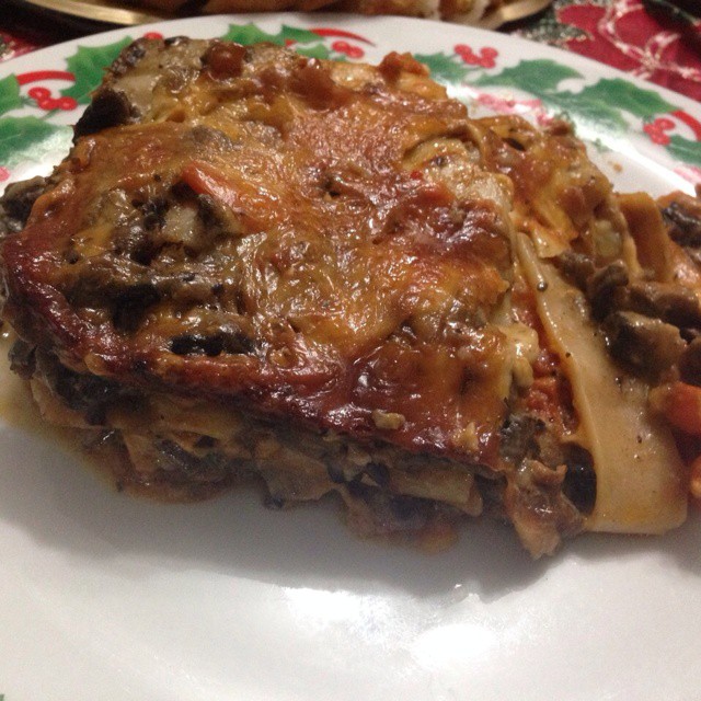 a close up of a plate of food with lasagna