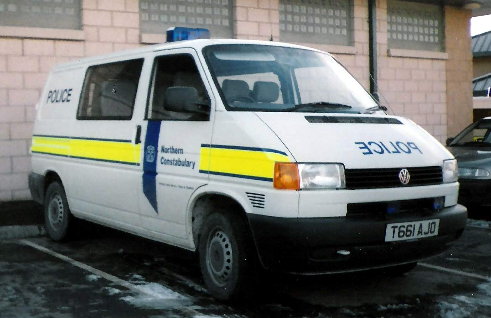 a white police van parked in a parking lot