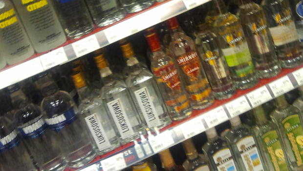a rack filled with bottles of alcohol sitting next to each other