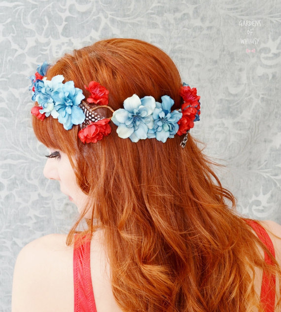 woman with red hair and blue flowers wearing a flower wreath