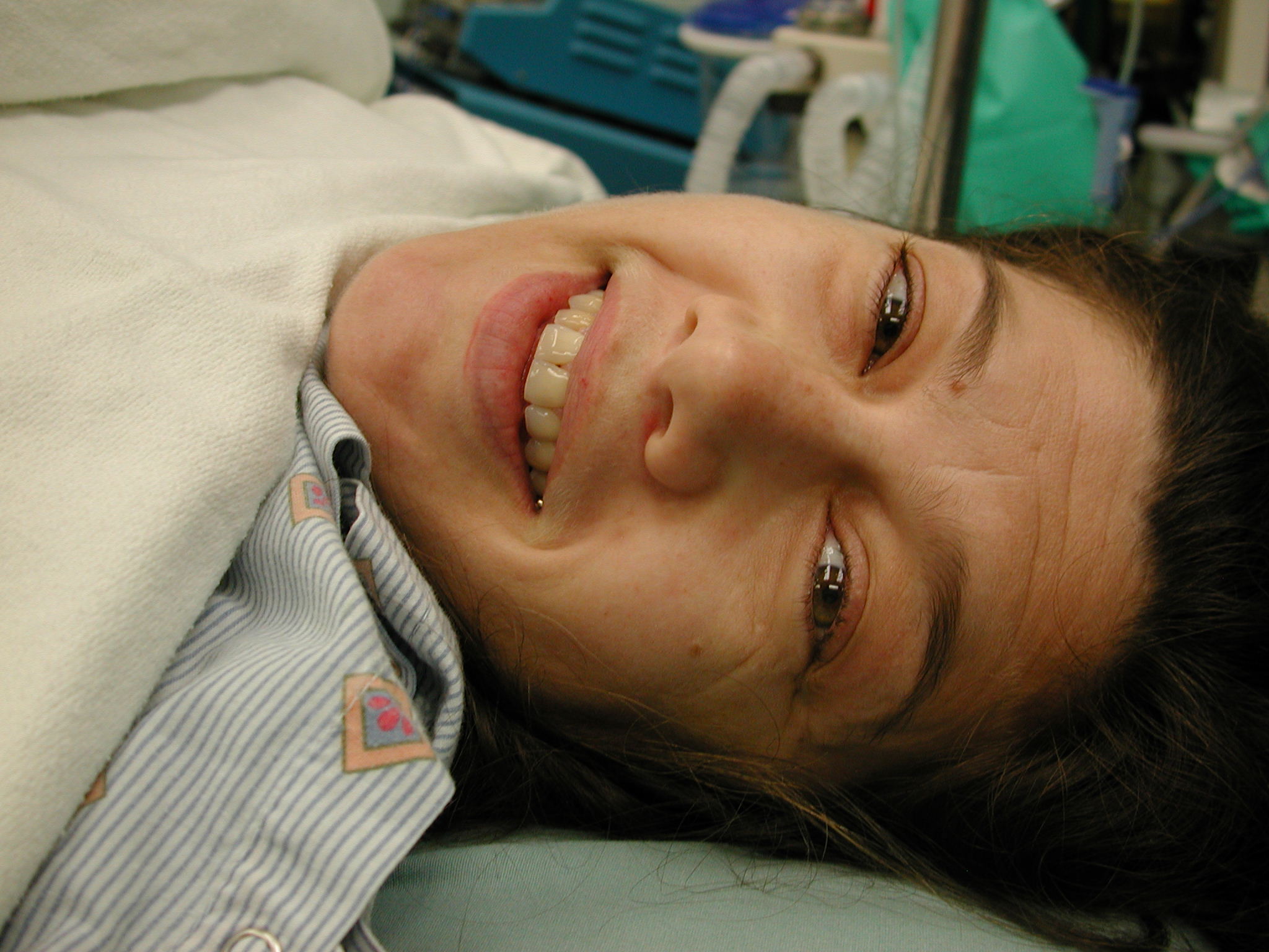 a young woman lying on a hospital bed