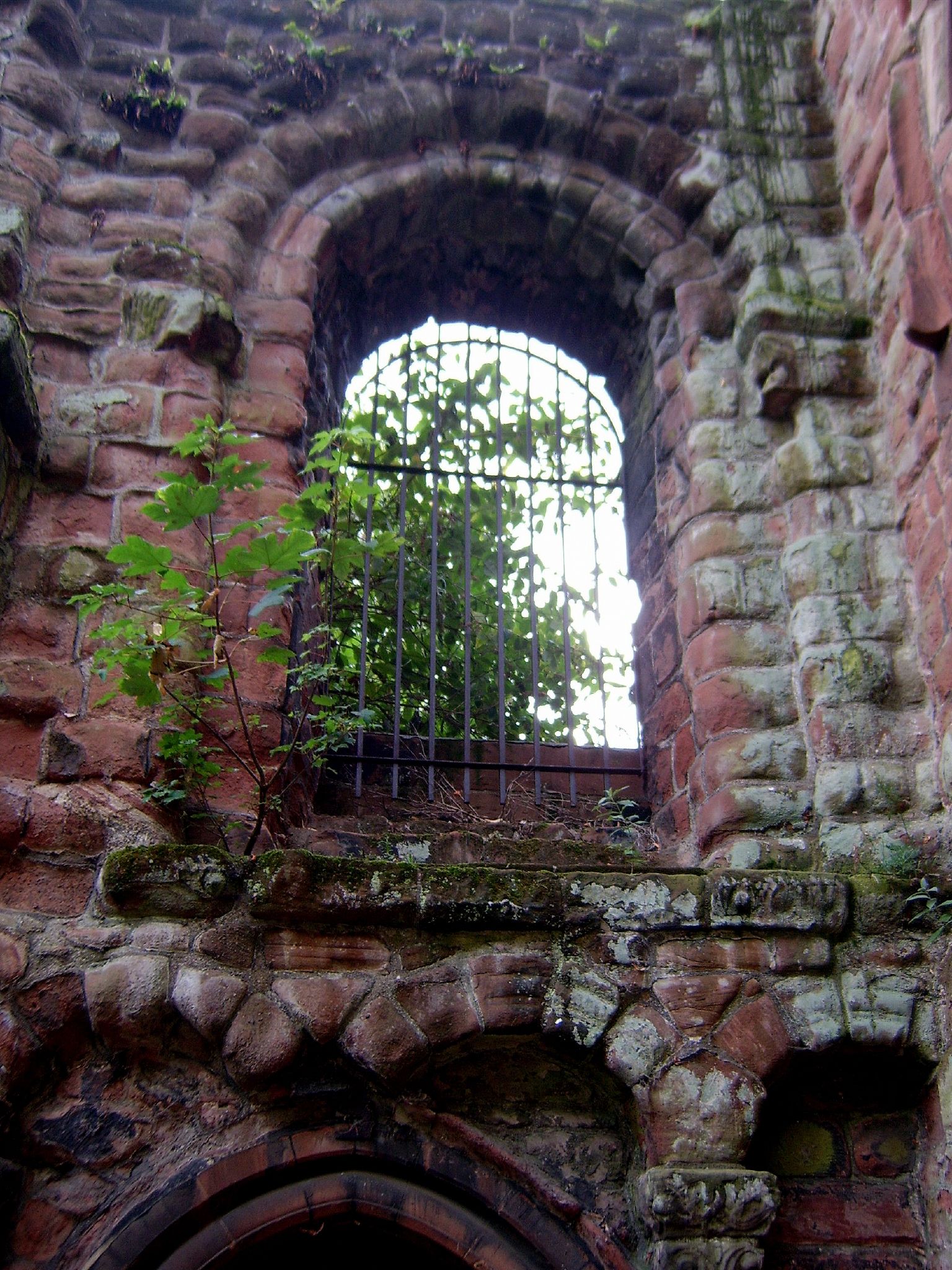 the remains of an old brick castle with a window in it