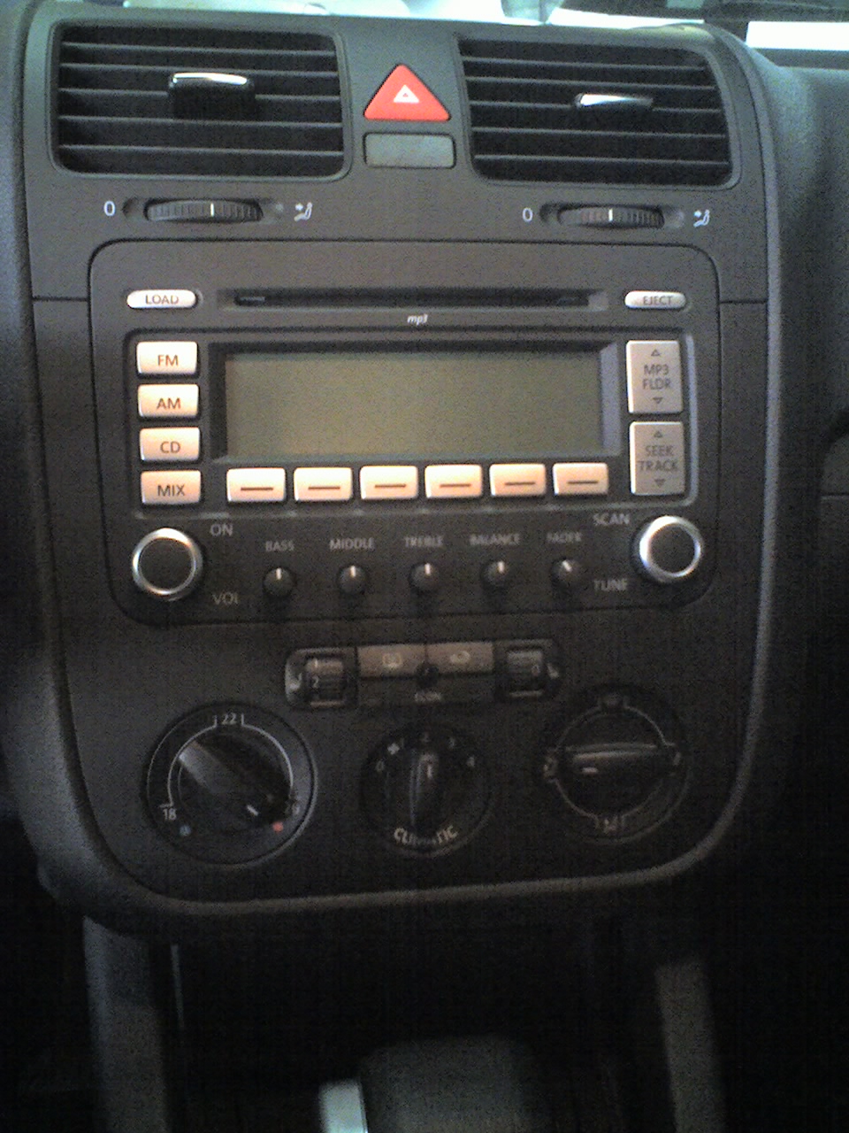 an electronic display is displayed on a radio in the cabin of a car