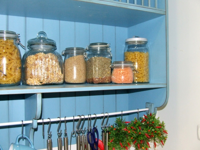 a blue shelf is full of different types of spices