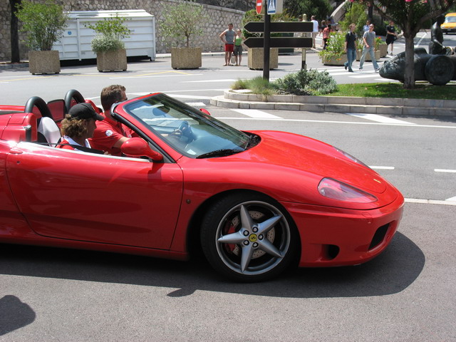 the young man has a big red sports car