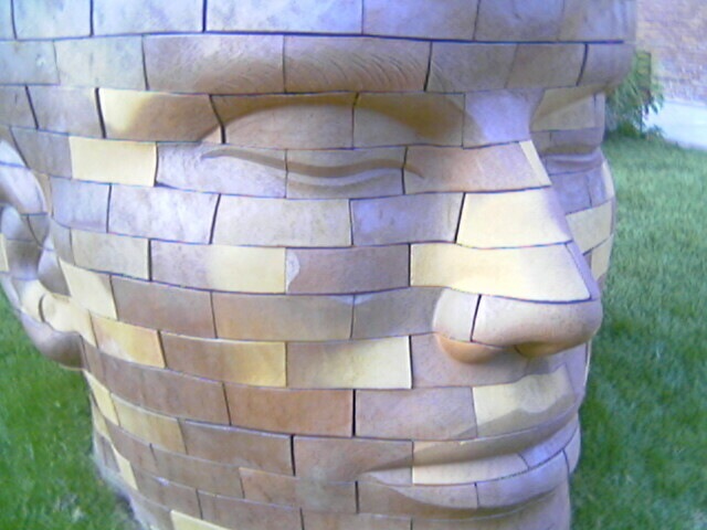a large brick statue of a person made of bricks
