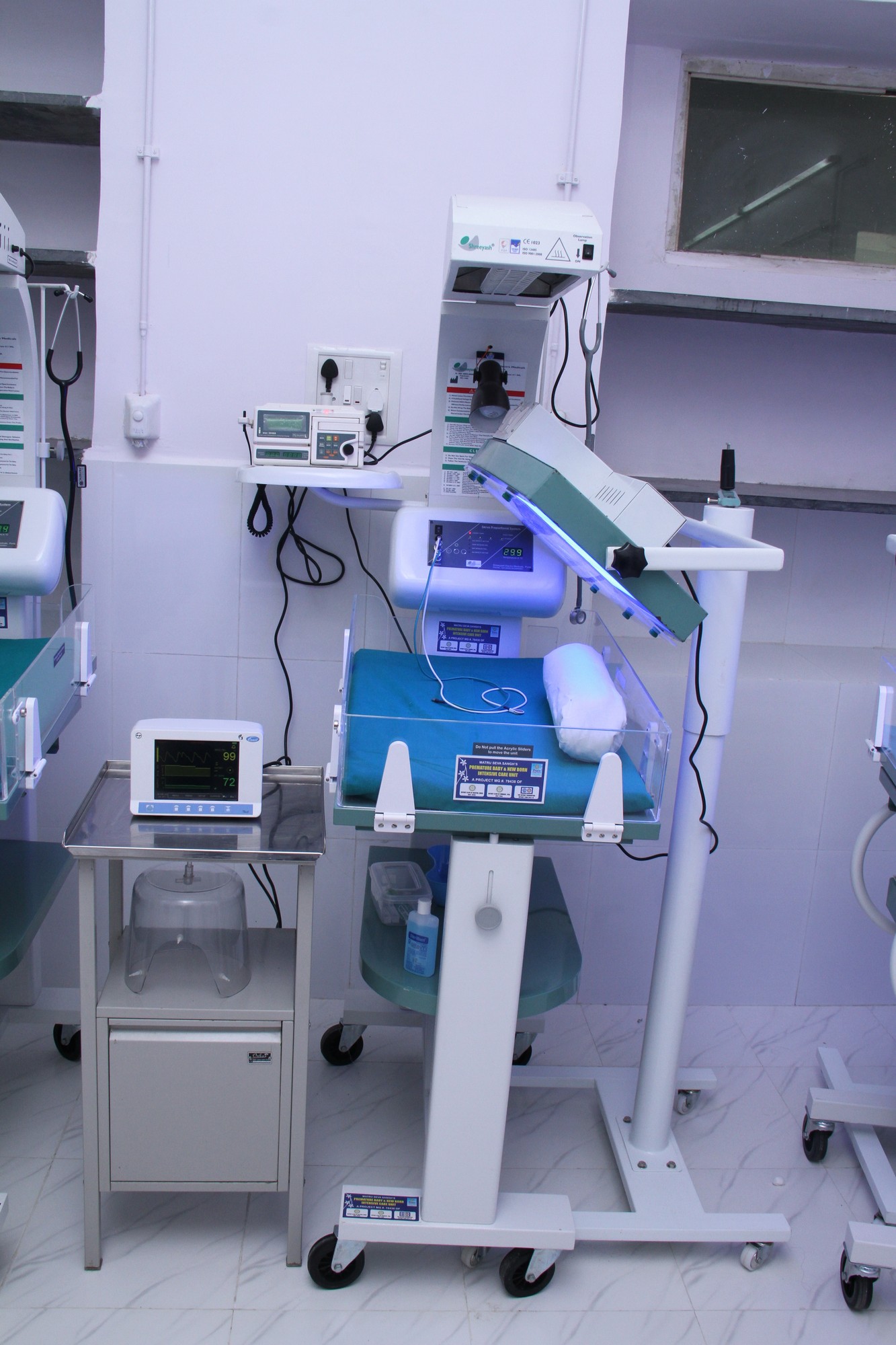 a hospital room with multiple machines and lights