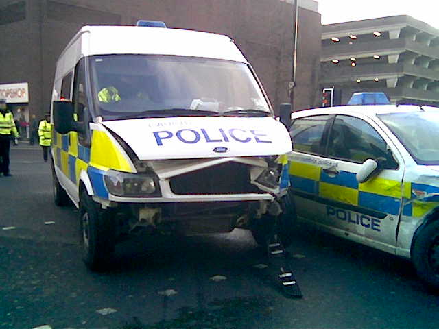 two police vehicles are parked in front of a building