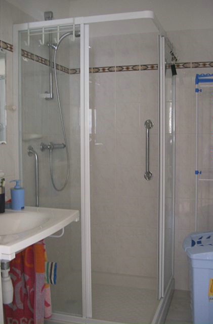 a large white shower with a glass door