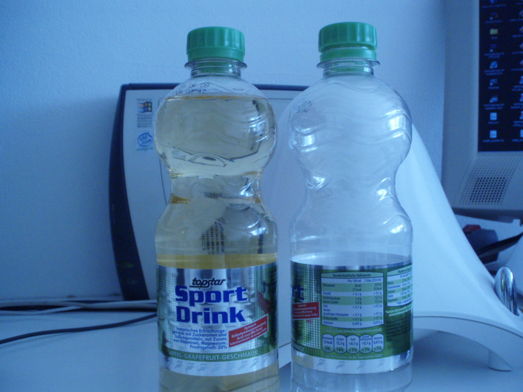 two bottles of water on a white desk