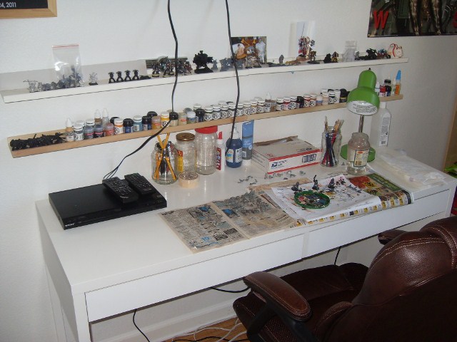 a room with a desk that has many things on it