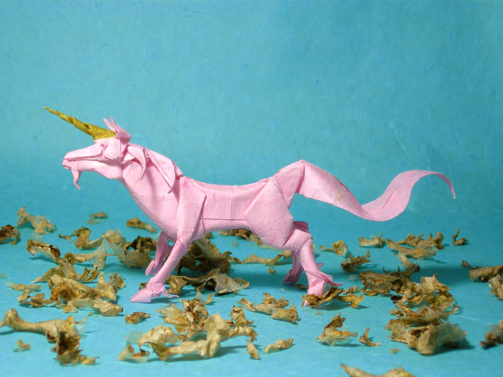 a pink unicorn horse toy with a golden horn