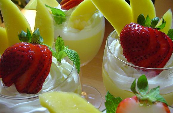 there are three glasses of some drinks with fruit garnish