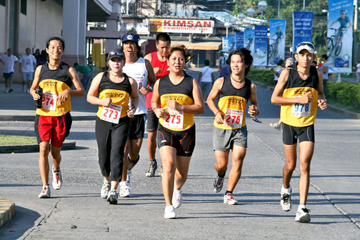 many people running in a race with the number 73 on their plates