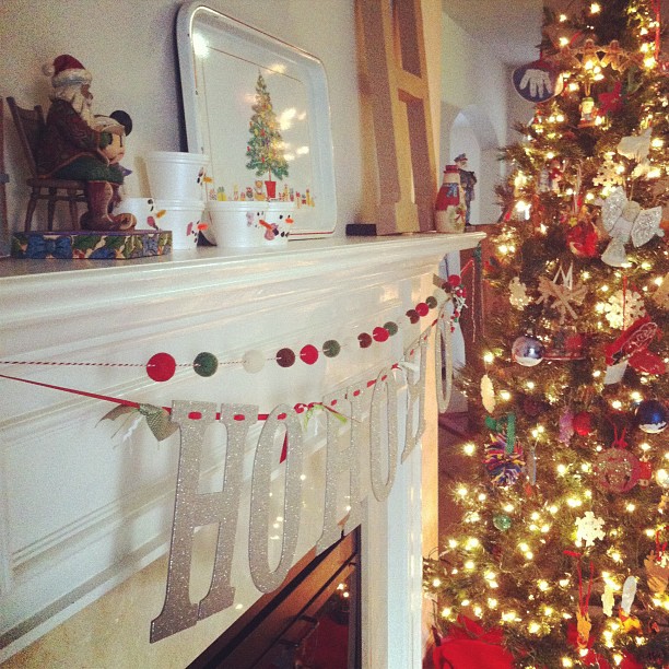 there is a decorated christmas tree near the mantle